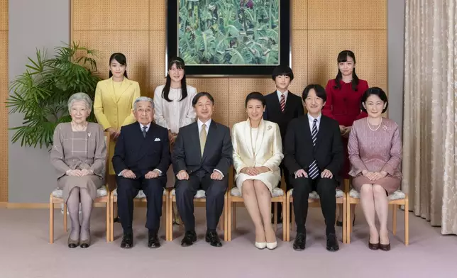 FILE - In this photo released by Imperial Household Agency of Japan, Japan's Emperor Naruhito, seated third from left, and Empress Masako, seated third from right, pose with their family members for a family photo session for the New Year, at their residence in Tokyo on Dec. 12, 2019. Imperial family members are, front left to right, Empress Emerita Michiko, Emperor Emeritus Akihito, Naruhito, Masako, Crown Prince Akishino, and Crown Princess Kiko, and, back from left to right, Princess Mako, Princess Aiko, Prince Hisahito, and Princess Kako. (Imperial Household Agency of Japan via AP, File)