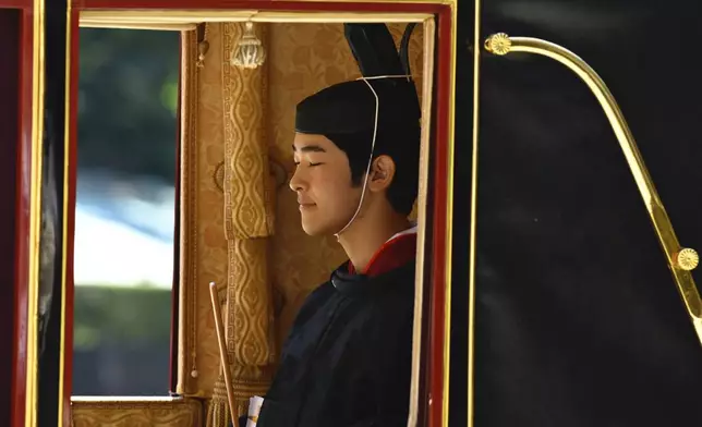Japan's Prince Hisahito is seen in traditional attire inside a horse-drawn carriage as he leaves the Imperial Palace after attending his coming-of-age ceremony to be recognized as an adult, on his 19th birthday in Tokyo, Saturday, Sept. 6, 2025. (David Mareuil/Pool Photo via AP)