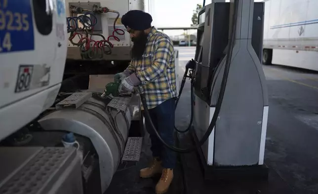 Sikh truck driver Prahb Singh fills up the tank of his truck at a gas station in Fontana, Calif., Wednesday, Sept. 3, 2025. (AP Photo/Jae C. Hong)
