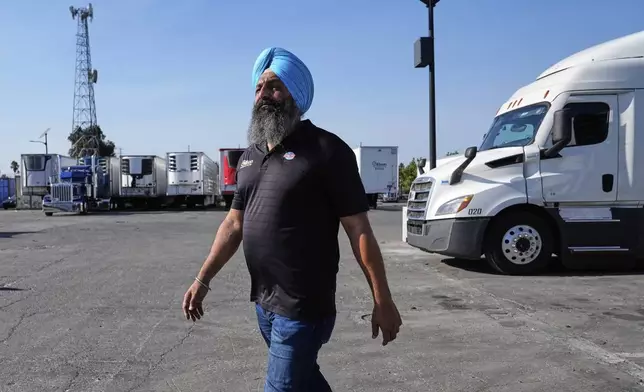 Harsimran Singh, owner of Gillson Trucking, walks through his lot in Stockton, Calif., Wednesday, Sept. 3, 2025. (AP Photo/Godofredo A. Vásquez)