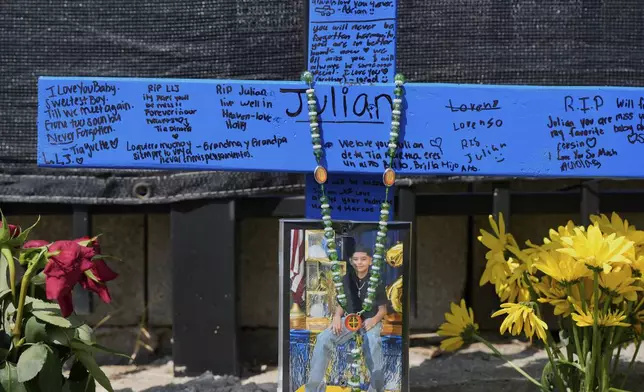 A makeshift memorial for 11-year-old Julian Guzman, who was shot and killed during a doorbell prank, is shown Tuesday, Sept. 2, 2025, in Houston. (AP Photo/David J. Phillip)