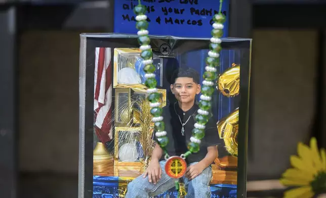 A makeshift memorial for 11-year-old Julian Guzman, who was shot and killed during a doorbell prank, is shown Tuesday, Sept. 2, 2025, in Houston. (AP Photo/David J. Phillip)