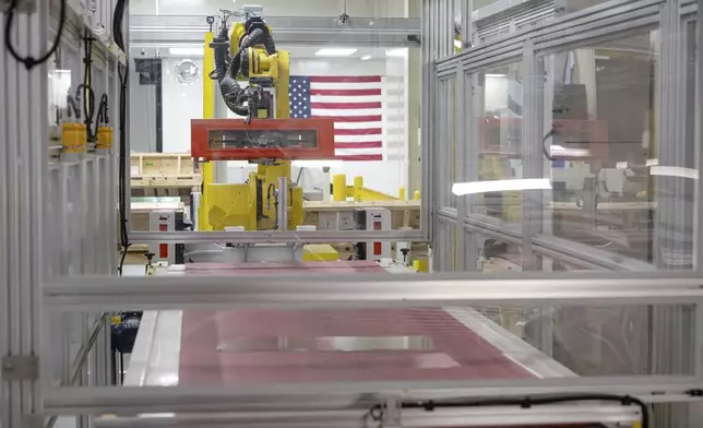 Lengths of glass move down a quality control line during a tour of Corning's iPhone glass manufacturing facility Friday, Sept. 12, 2025, in Harrodsburg, Ky. (AP Photo/Jon Cherry)