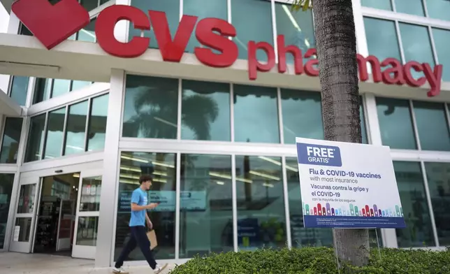 Vaccines are advertised outside a pharmacy in Miami, Thursday, Sept. 4, 2025. (AP Photo/Rebecca Blackwell)