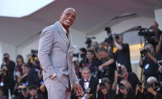 Dwayne Johnson poses for photographers on the red carpet for the film 'The Smashing Machine' during the 82nd edition of the Venice Film Festival in Venice, Italy, on Monday, Sept. 1, 2025. (Photo by Alessandra Tarantino/Invision/AP)