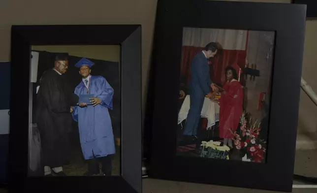 Framed photos of two of Delphine Cherry's children are displayed in her home Friday, Sept. 5, 2025, in Hazel Crest, Ill. Cherry lost two children, Tyler Randolph, left, seen, graduating from high school, and Tyesa Abney, right, seen, graduating from the eight grade, to shootings in and near Chicago. (AP Photo/Carolyn Kaster)