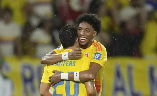 Colombia's Juan Fernando Quintero (20) celebrates with teammate Johan Mojica after scoring his side's third goal against Bolivia during a World Cup 2026 qualifying soccer match at Metropolitano stadium in Barranquilla, Colombia, Thursday, Sept. 4, 2025. (AP Photo/Fernando Vergara)