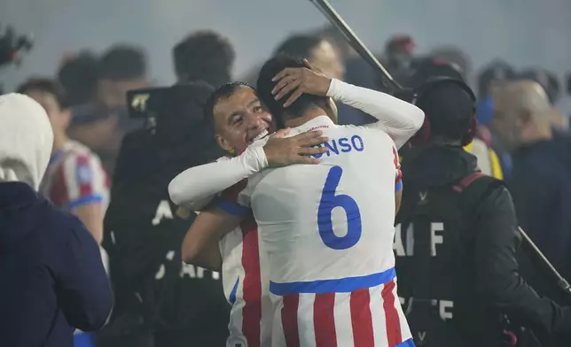 Paraguay's Alejandro Gamarra, back, and Junior Alonso embrace after qualifying for the FIFA World Cup 2026 after their match against Ecuador at Defensores del Chaco in Asuncion, Paraguay, Thursday, Sept. 4, 2025. (AP Photo/Jorge Saenz)
