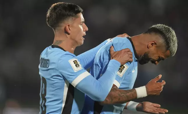 Uruguay's Rodrigo Aguirre, right, celebrates after scoring the opening goal against Peru during a World Cup 2026 qualifying soccer match in Montevideo, Uruguay, Thursday, Sept. 4, 2025. (AP Photo/Matilde Campodonico)