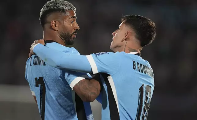 Uruguay's Rodrigo Aguirre, left, celebrates after scoring the opening goal against Peru uring a World Cup 2026 qualifying soccer match in Montevideo, Uruguay, Thursday, Sept. 4, 2025. (AP Photo/Matilde Campodonico)