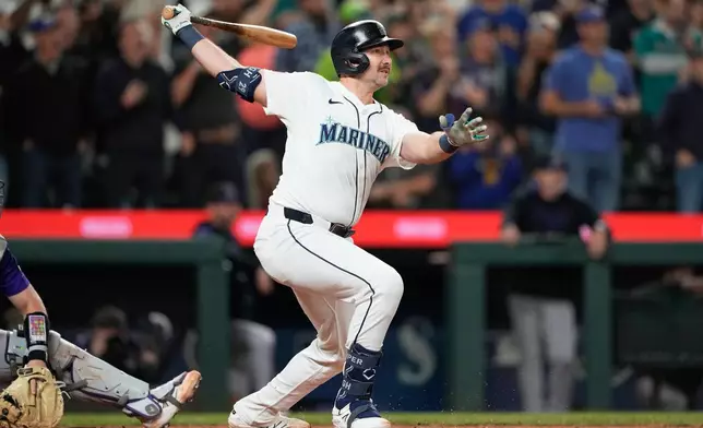 Seattle Mariners' Cal Raleigh watches his 60th home run during the eighth inning of a baseball game against the Colorado Rockies, Wednesday, Sept. 24, 2025, in Seattle. (AP Photo/Ryan Sun)