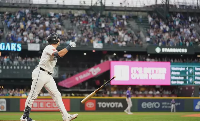 Seattle Mariners' Cal Raleigh tosses his bat after hitting a solo home run during the first inning of a baseball game against the Colorado Rockies, Wednesday, Sept. 24, 2025, in Seattle. (AP Photo/Ryan Sun)