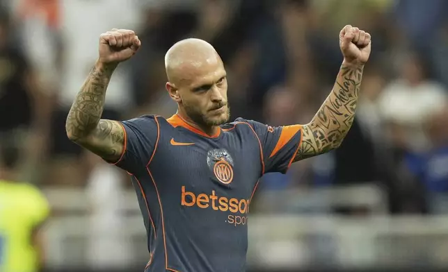 Inter Milan's Federico Dimarco celebrates after he scored his side's first goal during a Serie A soccer match between Inter Milan and Sassuolo, at San Siro stadium in Milan, Italy, Sunday, Sept. 21, 2025. (AP Photo/Antonio Calanni)