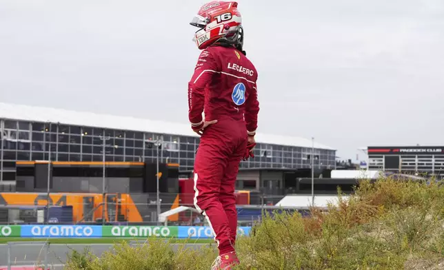 Ferrari driver Charles Leclerc of Monaco stands after a crash during the Formula One Dutch Grand Prix in Zandvoort, Netherlands, Sunday, Aug. 31, 2025. (AP Photo/Peter Dejong)