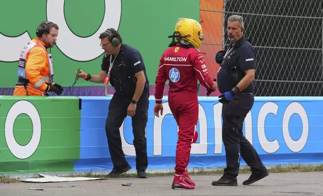 Ferrari driver Lewis Hamilton of Britain walks away after a crash during the Formula One Dutch Grand Prix in Zandvoort, Netherlands, Sunday, Aug. 31, 2025. (AP Photo/Peter Dejong)