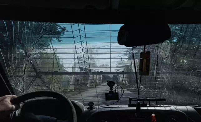A police van drives on the road with anti-drone nets near Kostiantynivka, Ukraine, Tuesday, Sept. 2, 2025. (AP Photo/Evgeniy Maloletka)
