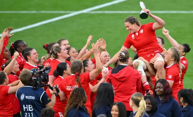 Canada's Sophie de Goede celebrates being named player of the tournament after the Women's Rugby World Cup final match between England and Canada at the Allianz Stadium, Twickenham in London, Saturday, Sept. 27, 2025.(AP Photo/Anthony Upton)