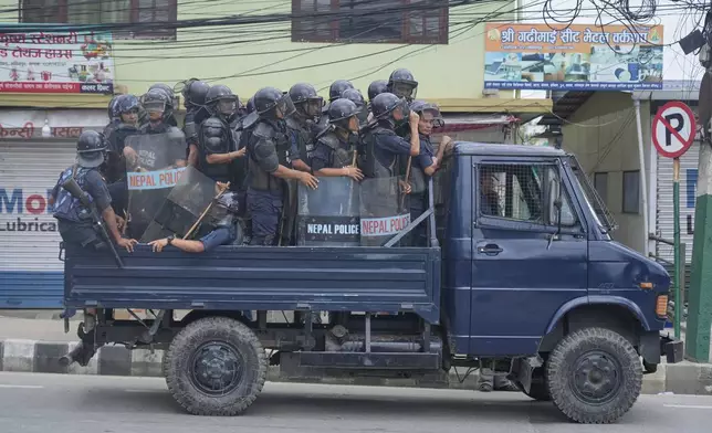 Policemen in riot gear patrol in a vehicle during curfew orders in Kathmandu, Nepal, Tuesday, Sept. 9, 2025. after Nepal’s government lifted its ban on social media platforms after violent street protests. (AP Photo/Niranjan Shrestha)