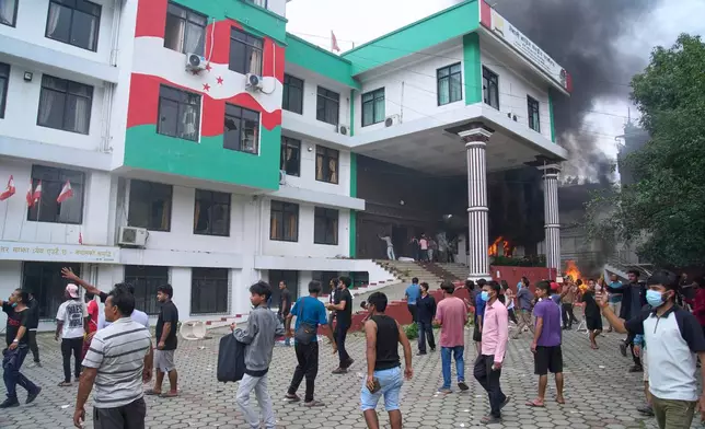 Protesters vandalize Nepalese congress party central office during protests against social media ban and corruption in Kathmandu, Nepal, Tuesday, Sept. 9, 2025. (AP Photo/Niranjan Shrestha)