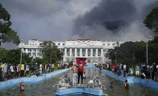 Protesters throng Singha Durbar, the seat of Nepal's government's various ministries and offices during a protest against social media ban and corruption in Kathmandu, Nepal, Tuesday, Sept. 9, 2025. (AP Photo/Niranjan Shrestha)