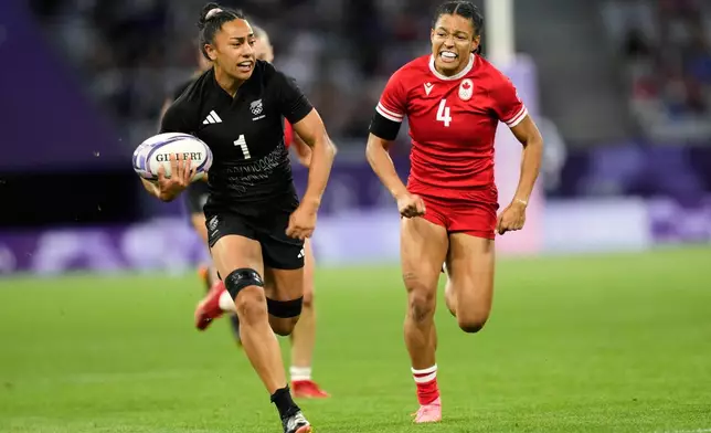 FILE - New Zealand's Risi Pouri-Lane, left, drives from the line past Canada's Asia Hogan-Rochester during the women's Pool A Rugby Sevens match between New Zealand and Canada at the 2024 Summer Olympics, in the Stade de France, in Saint-Denis, France, Sunday, July 28, 2024. (AP Photo/Tsvangirayi Mukwazhi, FIle)