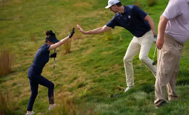 Europe's Catherine Zeta-Jones and Pau Gasol celebrate on the fifth hole during the celebrity Ryder Cup golf tournament, Wednesday, Sept. 24, 2025, on the Bethpage Black golf course, in Farmingdale, N.Y. (AP Photo/Matt Slocum)