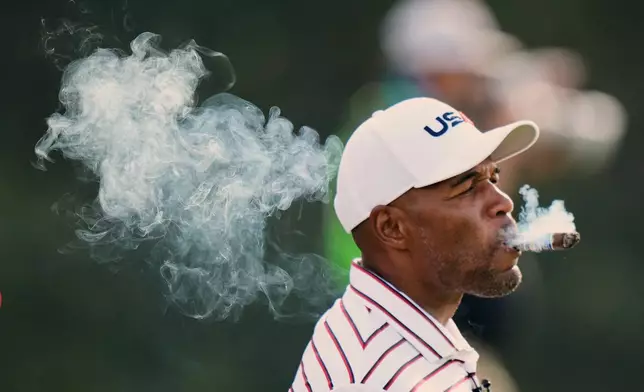 United States' Michael Strahan smokes on the fifth hole during the celebrity Ryder Cup golf tournament, Wednesday, Sept. 24, 2025, on the Bethpage Black golf course, in Farmingdale, N.Y. (AP Photo/Robert Bukaty)