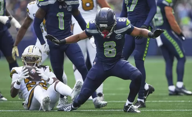 Seattle Seahawks safety Coby Bryant (8) reacts after tackling New Orleans Saints wide receiver Rashid Shaheed (22) during the first half of an NFL football game, Sunday, Sept. 21, 2025, in Seattle. (AP Photo/Lindsey Wasson)