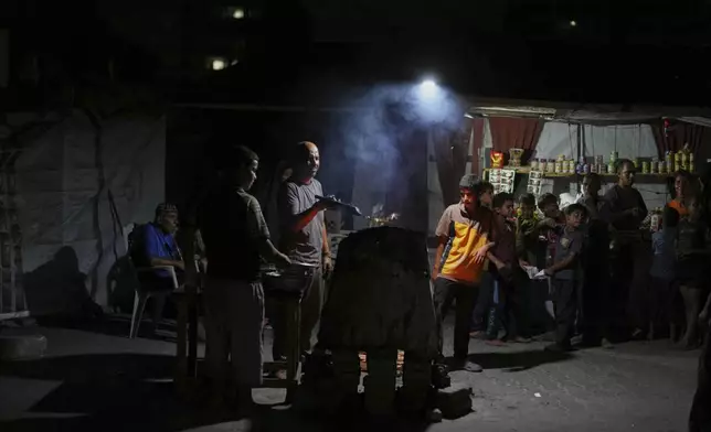 A Palestinian man fries falafels near the beachfront at a tent camp for displaced people in the Gaza City port, Tuesday, Sept. 2, 2025. (AP Photo/Jehad Alshrafi)