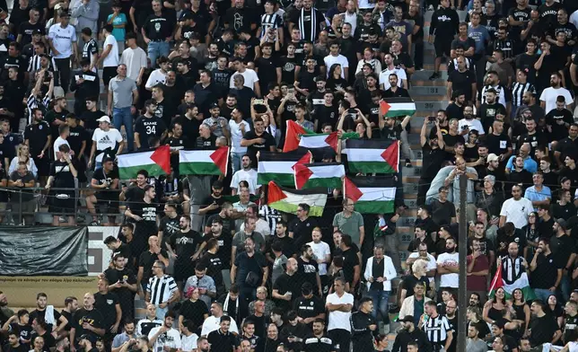 PAOK'S fans hold Palestinian Flags during the Europa League soccer match between PAOK and Maccabi Tel Aviv at Toumpa stadium, in Thessaloniki, Greece, Wednesday, Sept. 24, 2025. (AP Photo/Giannis Papanikos)