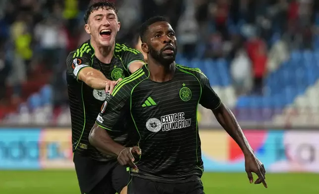 Celtic's Kelechi Iheanacho, right, celebrates after scoring his side's opening goal during the Europa League soccer match between Red Star and Celtic at the Rajko Mitic Stadium in Belgrade, Serbia, Wednesday, Sept. 24, 2025. (AP Photo/Darko Vojinovic)