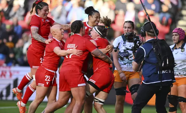 Canada's players celebrates a try during the Women's Rugby World Cup 2025 quarterfinal match between Canada and Australia, in Bristol, England, Saturday, Sept. 13, 2025. (AP Photo/Anthony Upton)