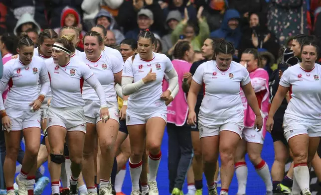England players celebrate scoring a try during the Women's Rugby World Cup 2025 quarterfinal match between England and Scotland in Bristol, England, Sunday, Sept. 14, 2025.(AP Photo/Anthony Upton)