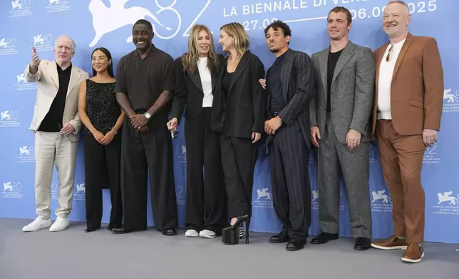 Tracy Letts, from left, Greta Lee, Idris Elba, director Kathryn Bigelow, Rebecca Ferguson, Anthony Ramos, Gabriel Basso and Jared Harris pose for photographers at the photo call for the film 'A House of Dynamite' during the 82nd edition of the Venice Film Festival in Venice, Italy, on Tuesday, Sept. 2, 2025. (Photo by Scott A Garfitt/Invision/AP)
