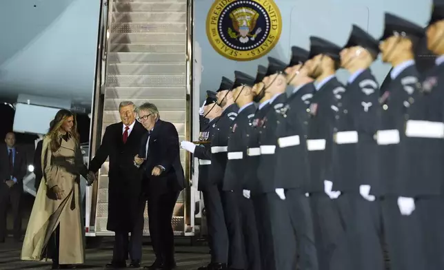 President Donald Trump and first lady Melania Trump are greeted by The Viscount Hood, Lord-in-Waiting, center, right, as they arrive at Stansted Airport near London, Tuesday, Sept. 16, 2025. (AP Photo/Evan Vucci)