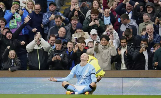 Manchester City's Erling Haaland celebrates after scoring during the Premier League soccer match between Manchester City and Manchester United in Manchester, England, Sunday, Sept. 14, 2025. (AP Photo/Dave Thompson)