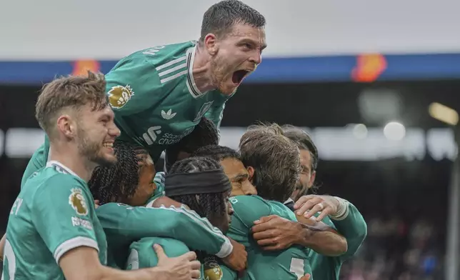Liverpool players celebrate after a goal during the Premier League soccer match between Burnley and Liverpool in Burnley, England, Sunday, Sept. 14, 2025. (AP Photo/Jon Super)