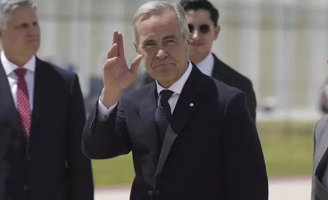 Canadian Prime Minister Mark Carney waves as he arrives in Mexico City, Thursday, Sept. 18, 2025. (Adrian Wyld/The Canadian Press via AP)