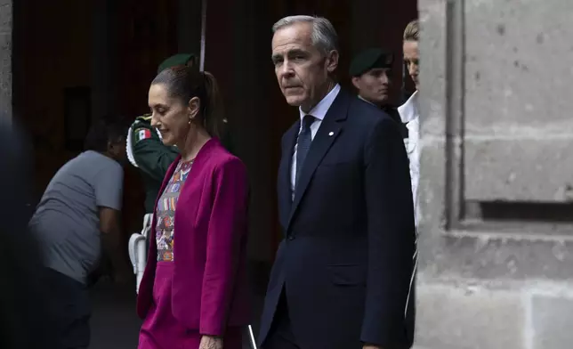 Canada's Prime Minister Mark Carney, right, and Mexican President Claudia Sheinbaum are seen during an official welcome ceremony at the National Palace in Mexico City, Thursday, Sept. 18, 2025. (Adrian Wyld/The Canadian Press via AP)