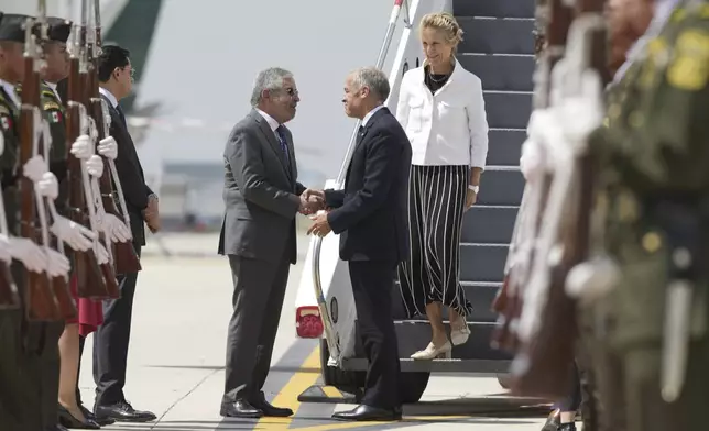 Canada's Prime Minister Mark Carney and his wife Diana Fox Carney are greeted by Mexican Secretary of Foreign Affairs Juan Ramon de la Fuente as they arrive in Mexico City, Thursday, Sept. 18, 2025. (Adrian Wyld/The Canadian Press via AP)