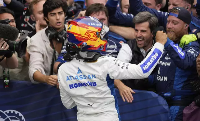 Williams driver Carlos Sainz of Spain celebrates second place with his team at the Azerbaijan Formula One Grand Prix in Baku, Azerbaijan, Sunday, Sept. 21, 2025. (AP Photo/Darko Bandic)