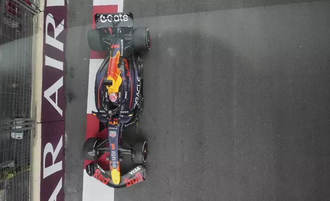 Red Bull driver Max Verstappen of the Netherlands shot in action through a glass during the Azerbaijan Formula One Grand Prix in Baku, Azerbaijan, Sunday, Sept. 21, 2025. (AP Photo/Darko Bandic)