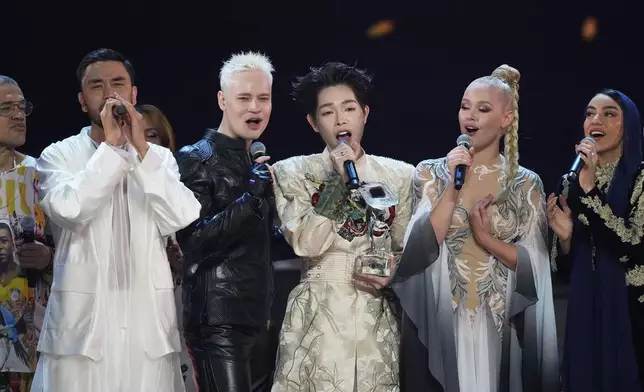 Vietnam's Duc Phuc, center, the winner of the International Music Competition "Intervision" and other participants sing at the Live Arena outside Moscow, Russia, Sunday, Sept. 21, 2025. (AP Photo/Alexander Zemlianichenko)