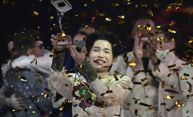 Vietnam's Duc Phuc celebrates with his trophy after winning the International Music Competition "Intervision" at the Live Arena outside Moscow, Russia, Sunday, Sept. 21, 2025. (AP Photo/Alexander Zemlianichenko)