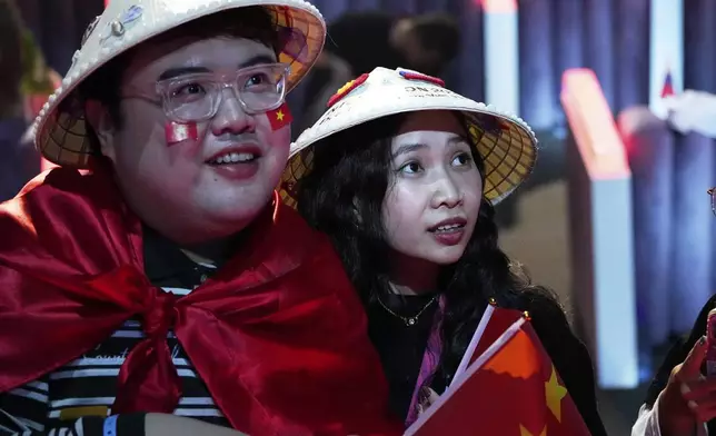 Fans of Vietnam's Duc Phuc watch his performance at the International Music Competition "Intervision" at the Live Arena outside Moscow, Russia, Saturday, Sept. 20, 2025. (AP Photo/Alexander Zemlianichenko)