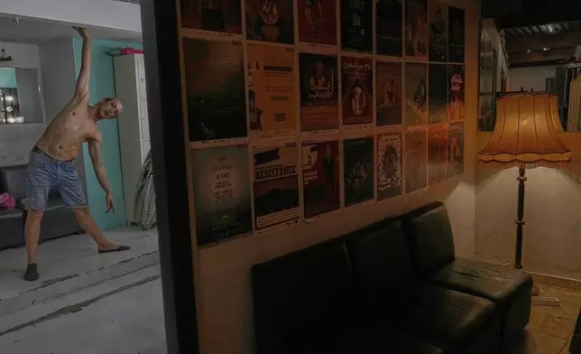 Alexandre Paulikevitch stretches backstage as he gets ready to perform at a theatre in Beirut, Lebanon, Thursday, Sept. 11, 2025. (AP Photo/Hussein Malla)