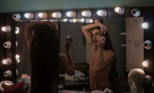 Alexandre Paulikevitch applies makeup backstage before performing at a theatre in Beirut, Lebanon, Thursday, Sept. 11, 2025. (AP Photo/Hussein Malla)