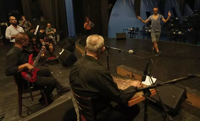 Alexandre Paulikevitch rehearses with musicians at a theatre in Beirut, Lebanon, Thursday, Sept. 11, 2025. (AP Photo/Hussein Malla)