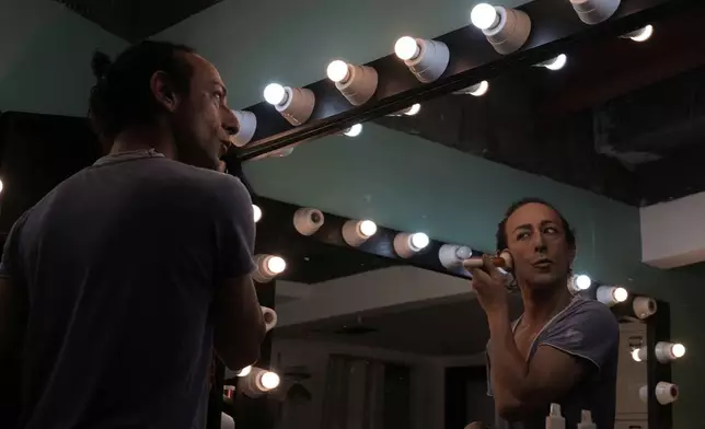 Alexandre Paulikevitch applies makeup backstage before performing at a theatre in Beirut, Lebanon, Thursday, Sept. 11, 2025. (AP Photo/Hussein Malla)