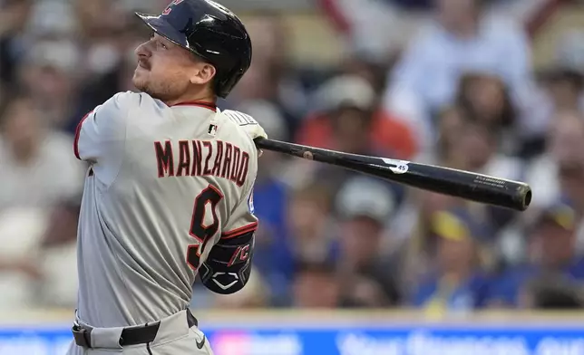 Cleveland Guardians' Kyle Manzardo (9) hits a single against the Minnesota Twins in the third inning of the second baseball game of a doubleheader, Saturday, Sept. 20, 2025, in Minneapolis. (AP Photo/Mike Stewart)